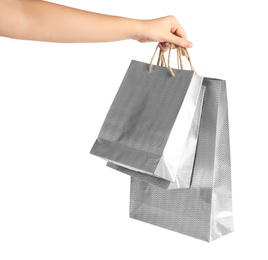 Photo of Woman holding paper shopping bags on white background, closeup. Space for design