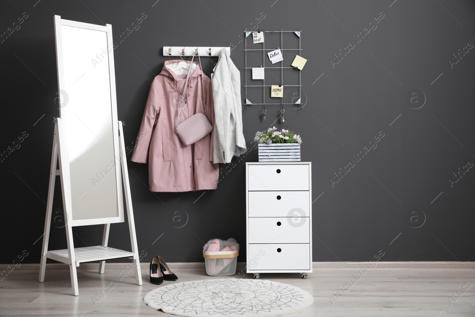 Photo of Hallway interior with stylish furniture, clothes and accessories
