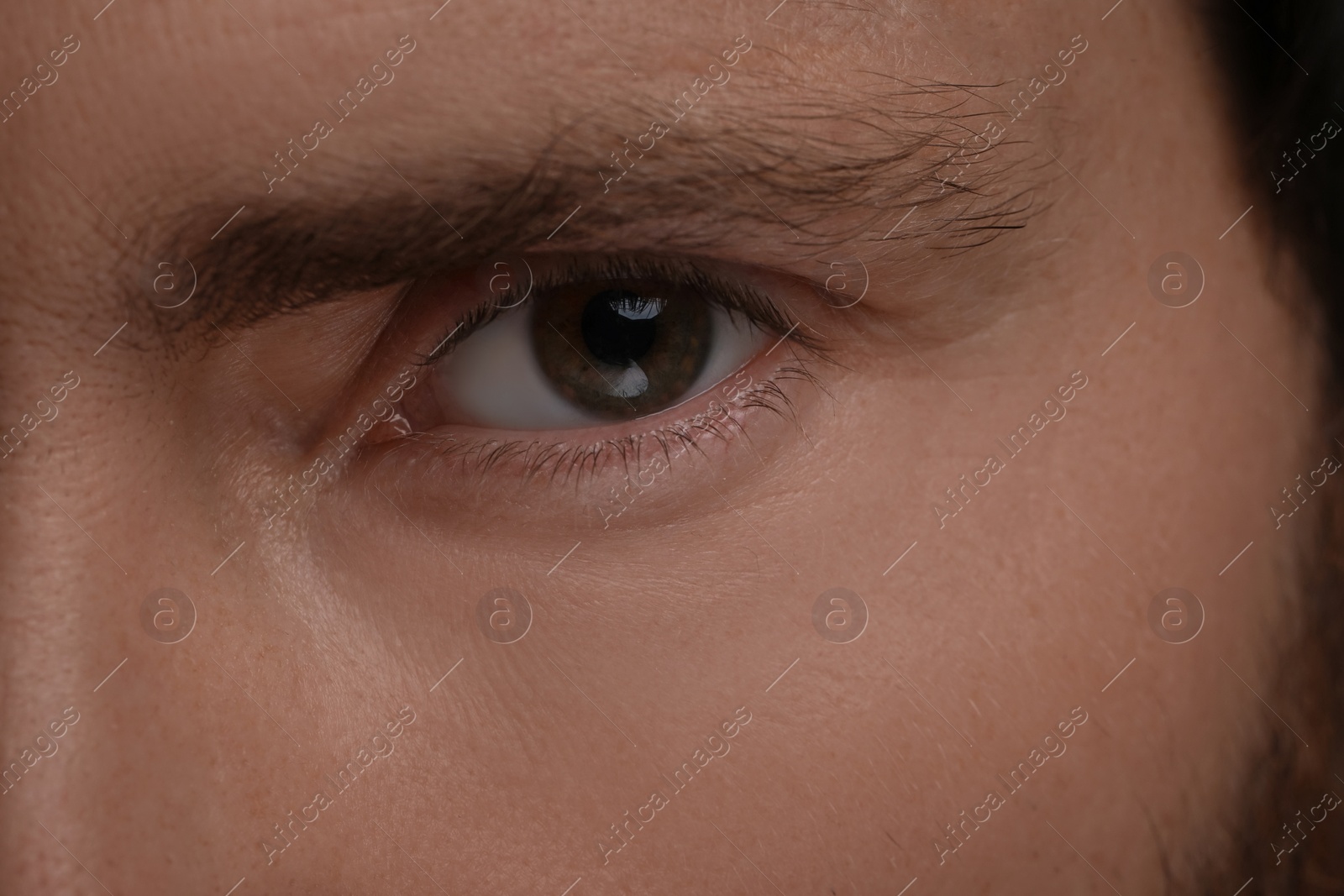 Photo of Evil eye. Man with scary eyes, closeup view