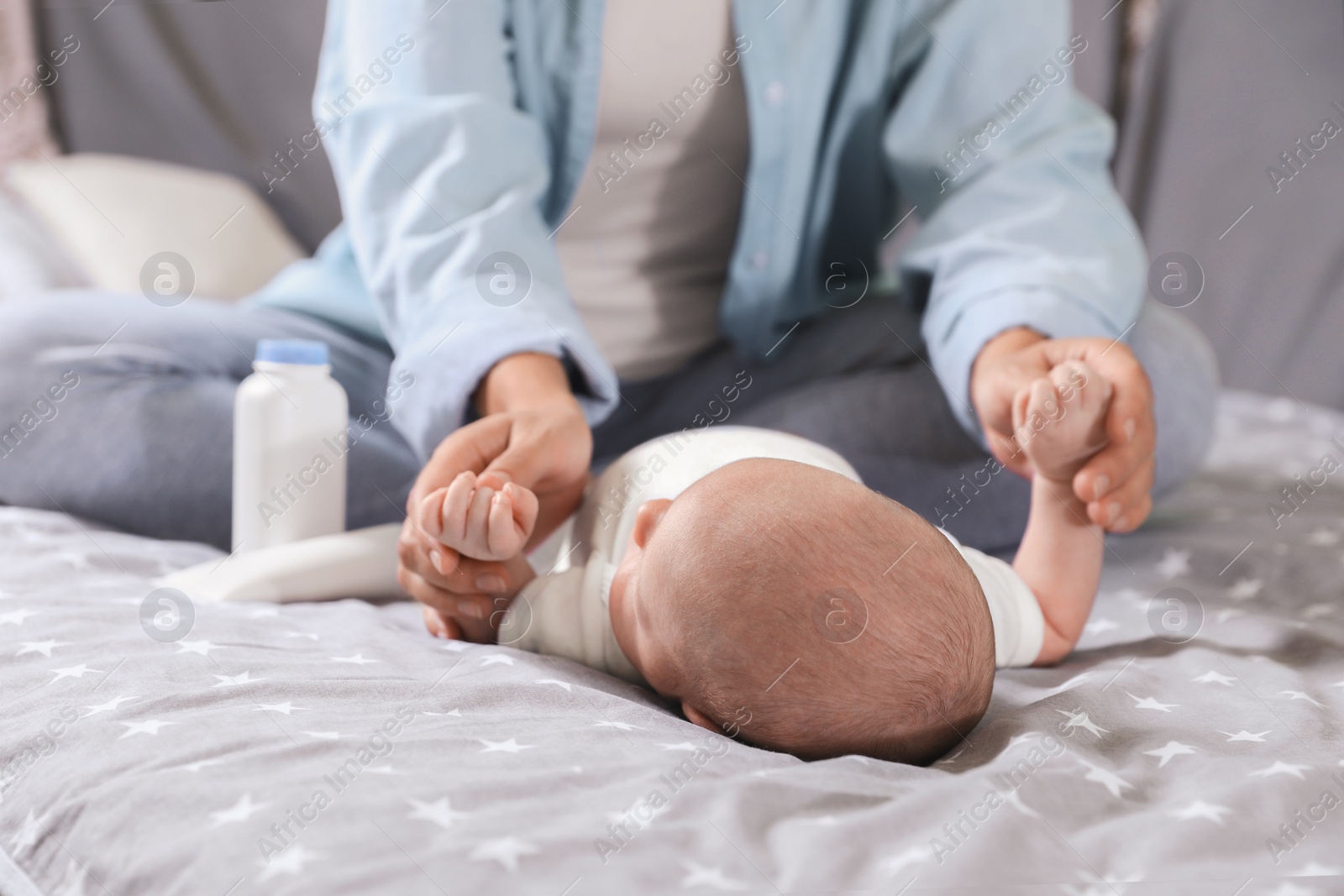 Photo of Mother and her little baby on bed, closeup