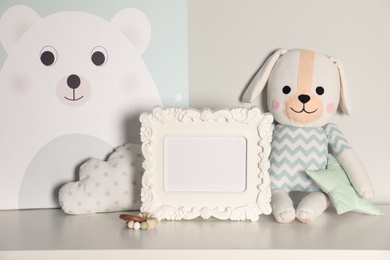 Composition with cute children's room interior elements on table against light background