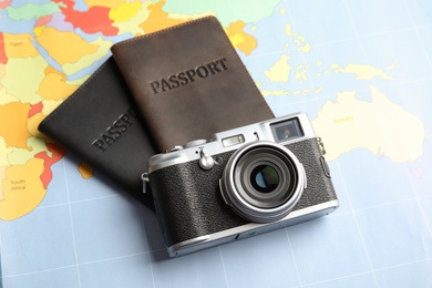 Passports and camera on world map. Travel agency