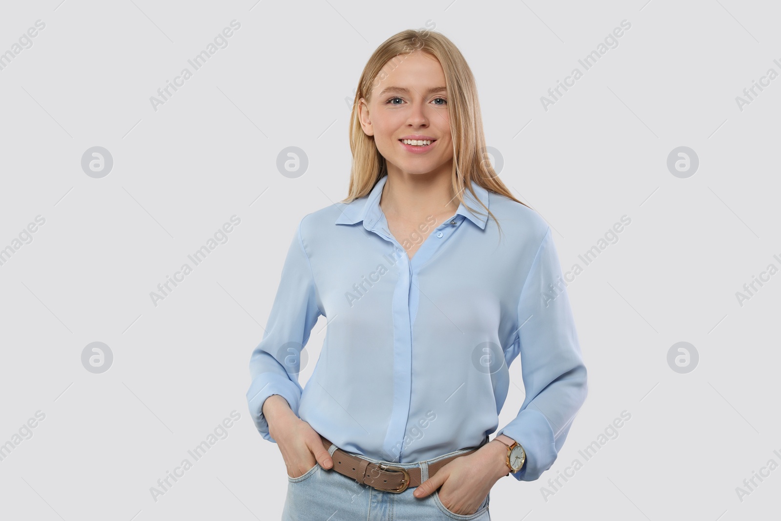 Photo of Portrait of beautiful young woman in stylish blouse on white background