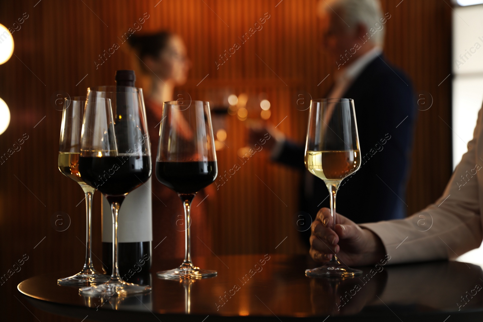 Photo of Woman with glass of wine in restaurant, closeup