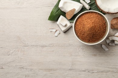 Photo of Flat lay composition with natural coconut sugar on white wooden table, space for text
