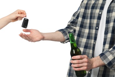 Photo of Woman giving car keys to man with bottle of beer on white background, closeup. Don't drink and drive concept