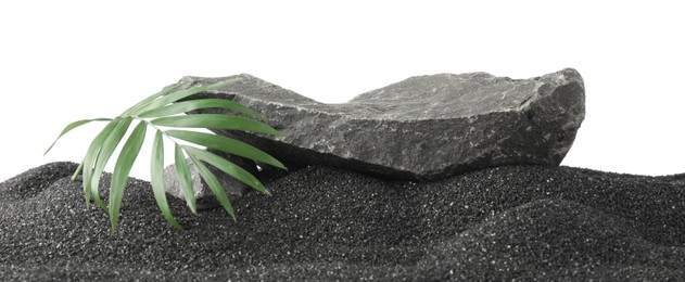 Photo of Presentation of product. Stone podium and palm leaves on black sand against white background