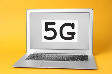 Internet concept. Laptop with 5G card on yellow background