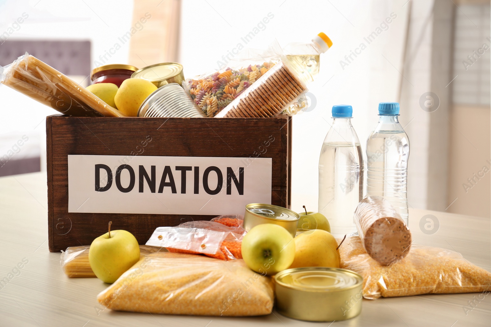 Photo of Donation box and different products on table indoors