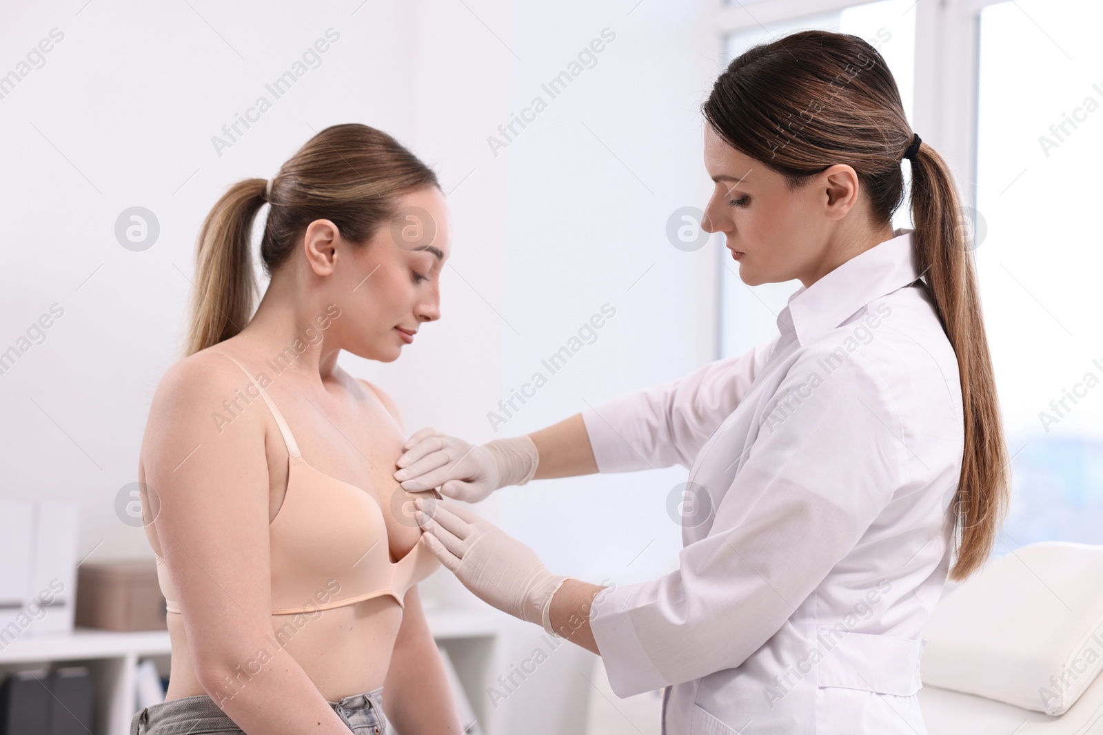 Photo of Mammologist checking young woman's breast in hospital