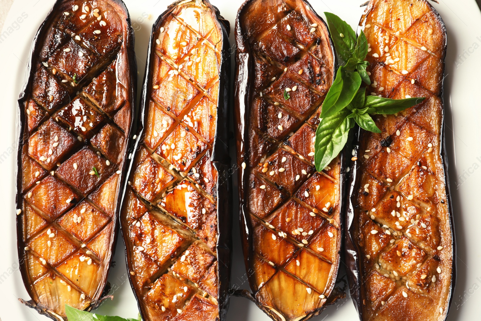 Photo of Plate with fried eggplant slices, top view