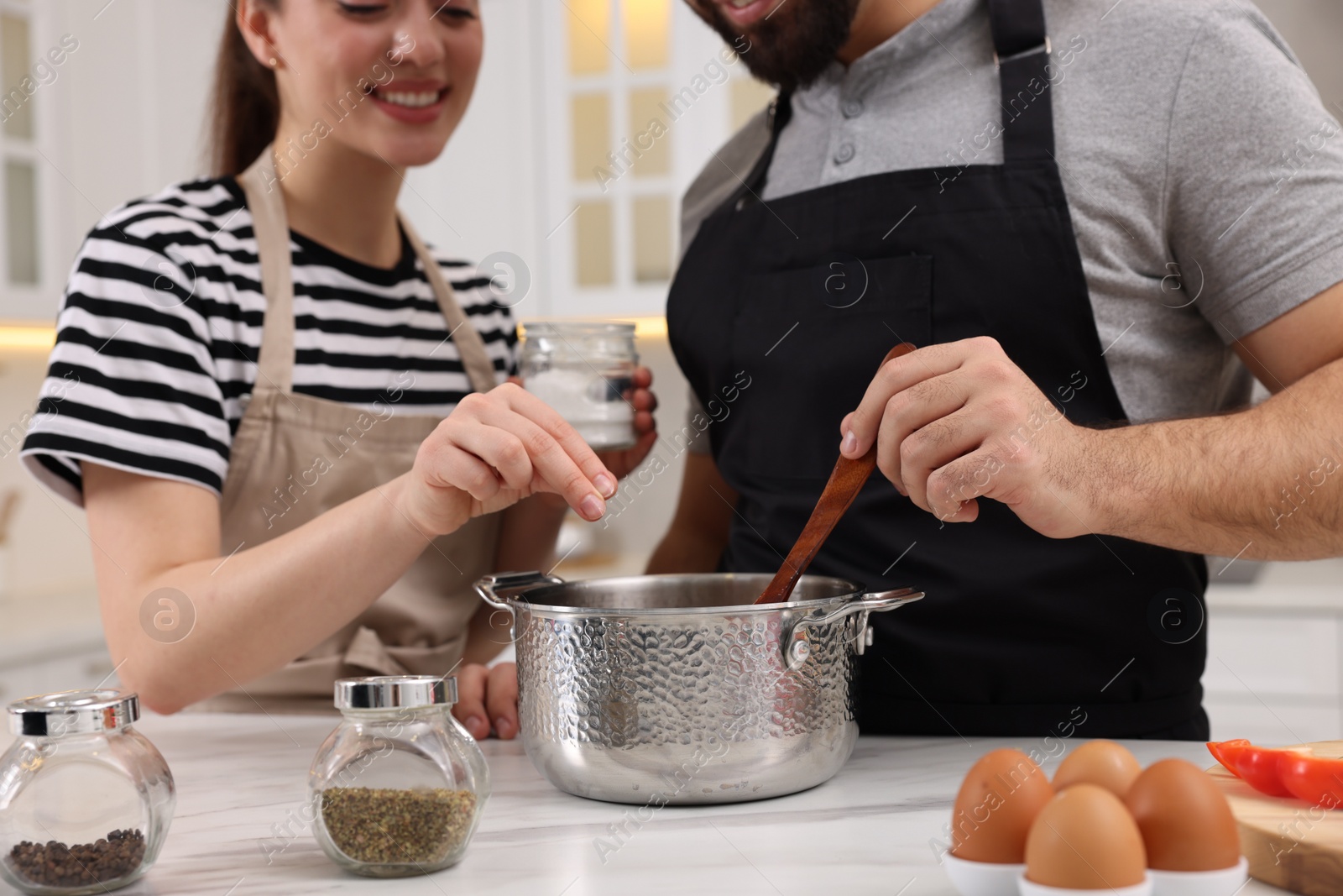 Photo of Lovely couple cooking together in kitchen, closeup