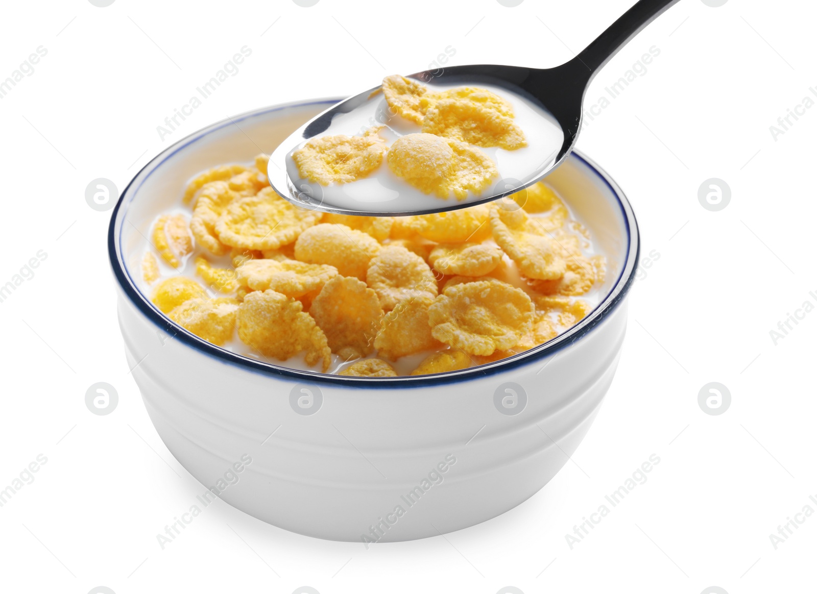 Photo of Spoon of delicious crispy corn flakes with milk above bowl on white background