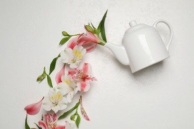 Photo of Composition with beautiful flowers and teapot on light background, top view