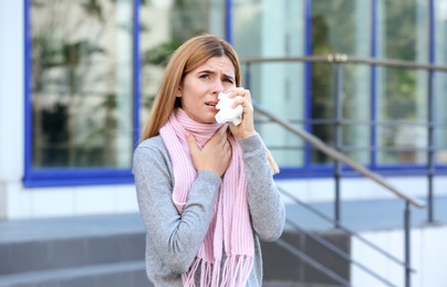 Photo of Woman suffering from cough and cold outdoors