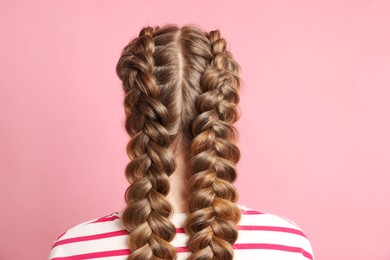 Photo of Woman with braided hair on pink background, back view