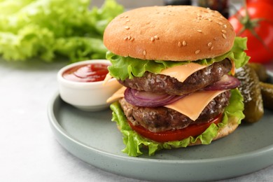 Photo of Tasty hamburger with patty, cheese and vegetables served on light gray table, closeup