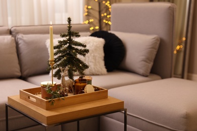 Photo of Composition with decorative Christmas tree and reindeer on wooden tray in living room