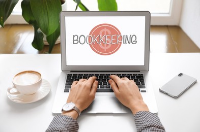 Bookkeeping concept. Woman working with laptop at white table, closeup