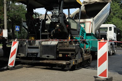 Photo of Road repair machinery working on city street