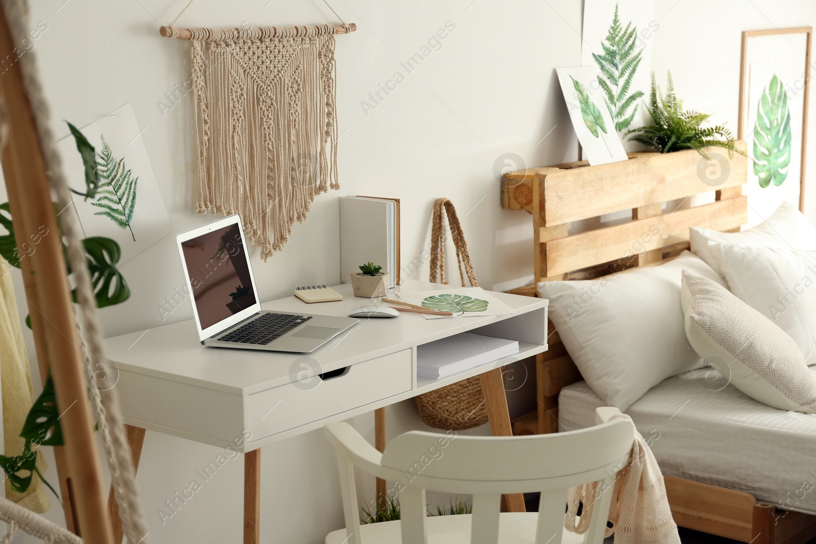 Photo of Stylish room interior with workplace and bed