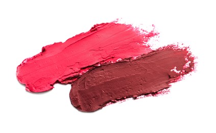 Photo of Smears of beautiful lipsticks on white background, top view