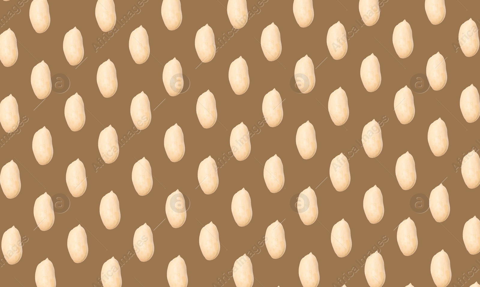 Image of Pattern of peeled peanuts on brown background