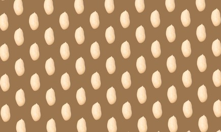 Pattern of peeled peanuts on brown background