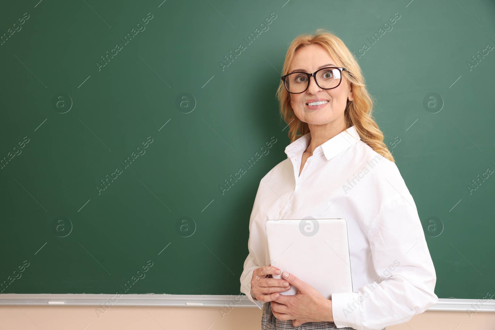 Photo of Happy professor with glasses near green board, space for text