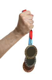 Man holding medals on white background, closeup. Space for design