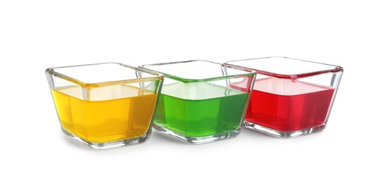 Tasty jelly desserts in glass bowls on white background