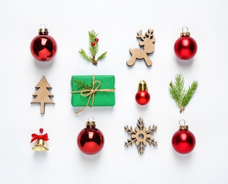 Flat lay composition with Christmas gift and festive decor on white background