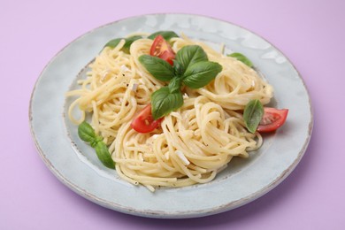 Photo of Delicious pasta with brie cheese, tomatoes and basil leaves on violet background, closeup