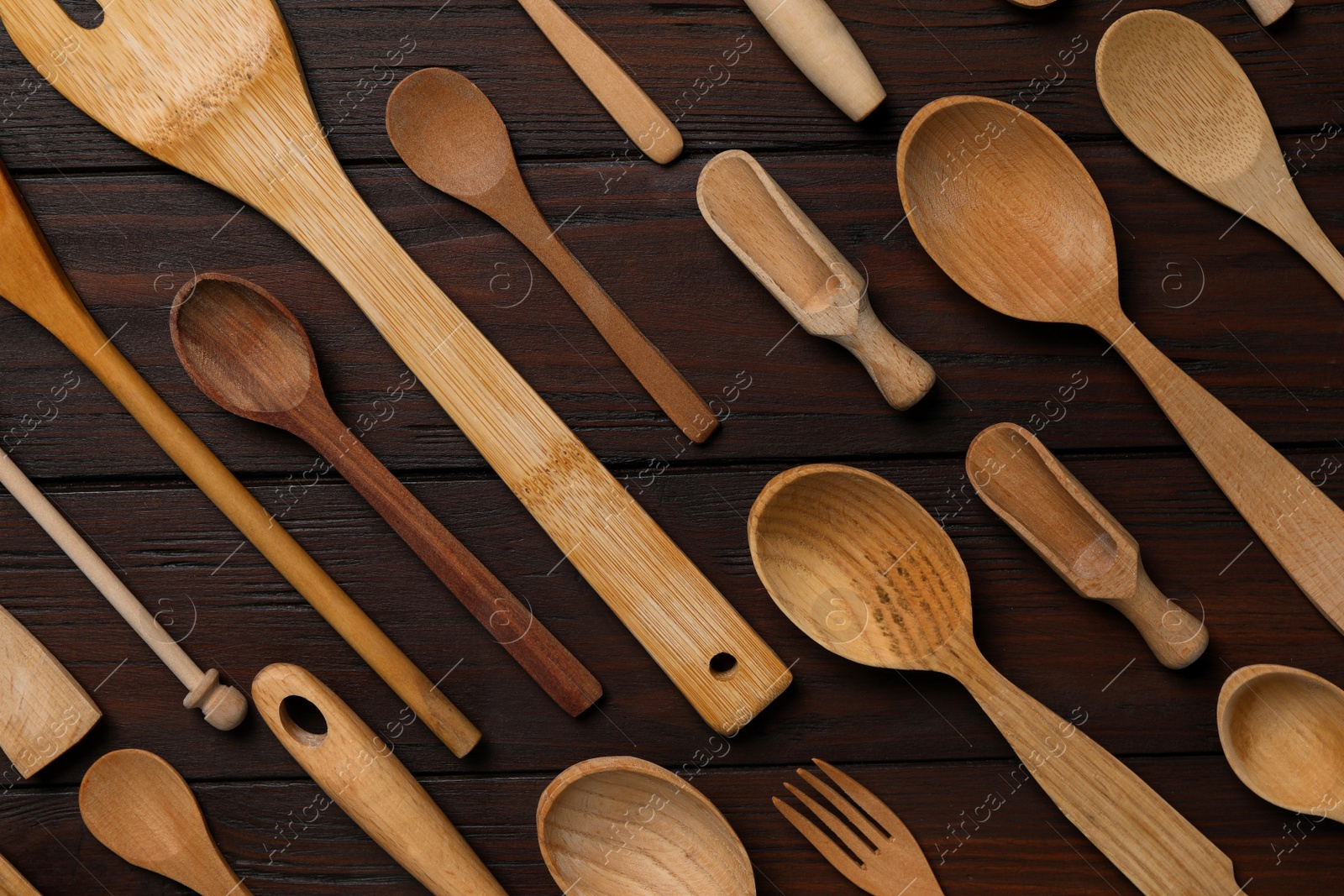 Photo of Set of modern cooking utensils on brown wooden table, flat lay