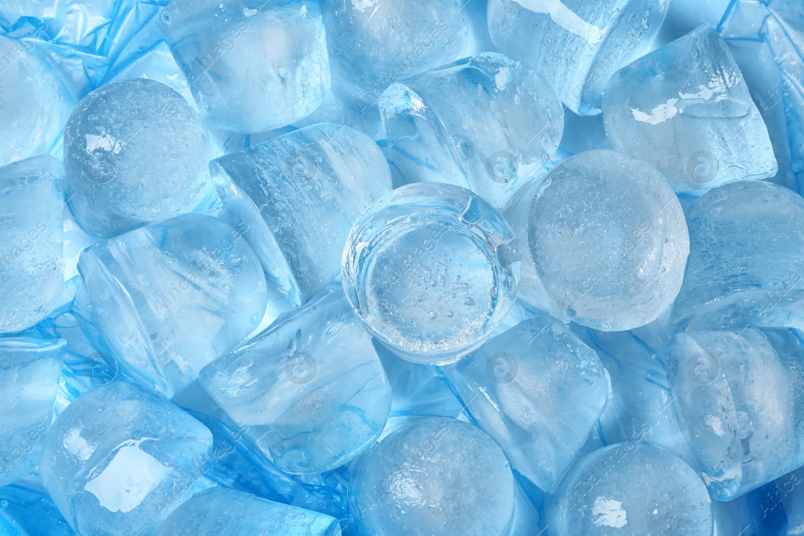 Photo of Many pieces of ice  on color background, top view