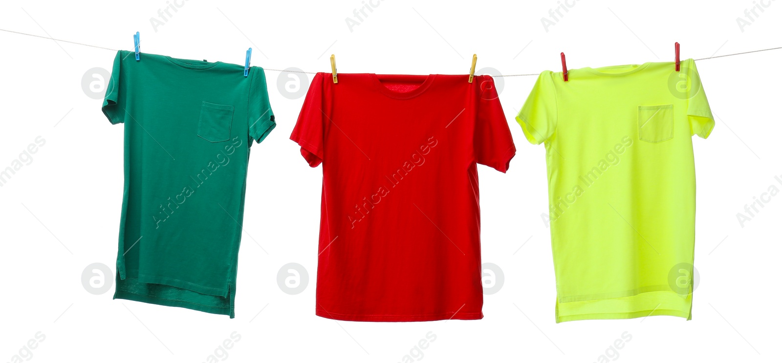 Photo of Colorful t-shirts drying on washing line isolated on white