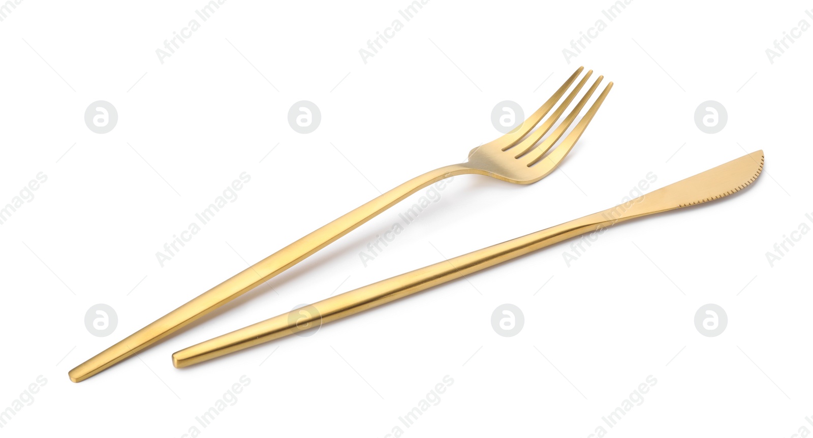 Photo of Shiny golden fork and knife isolated on white. Luxury cutlery