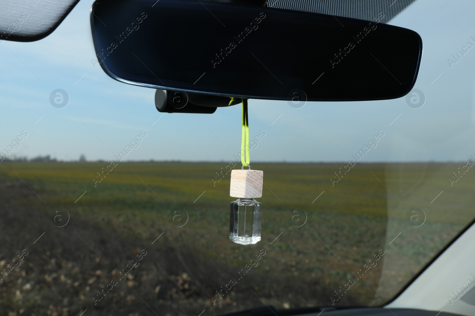 Photo of Air freshener hanging on rear view mirror in car