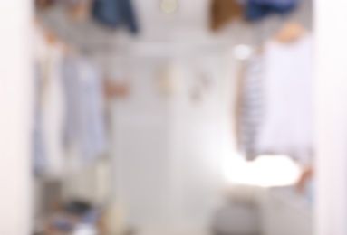 Photo of Blurred view of modern dressing room with stylish clothes