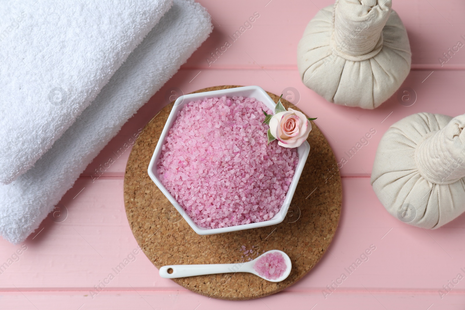 Photo of Flat lay composition with sea salt and herbal bags on pink wooden table