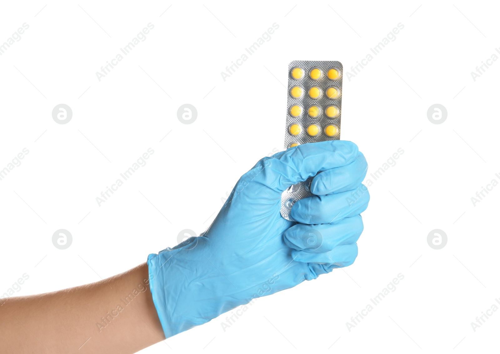 Photo of Doctor in medical glove holding pills on white background