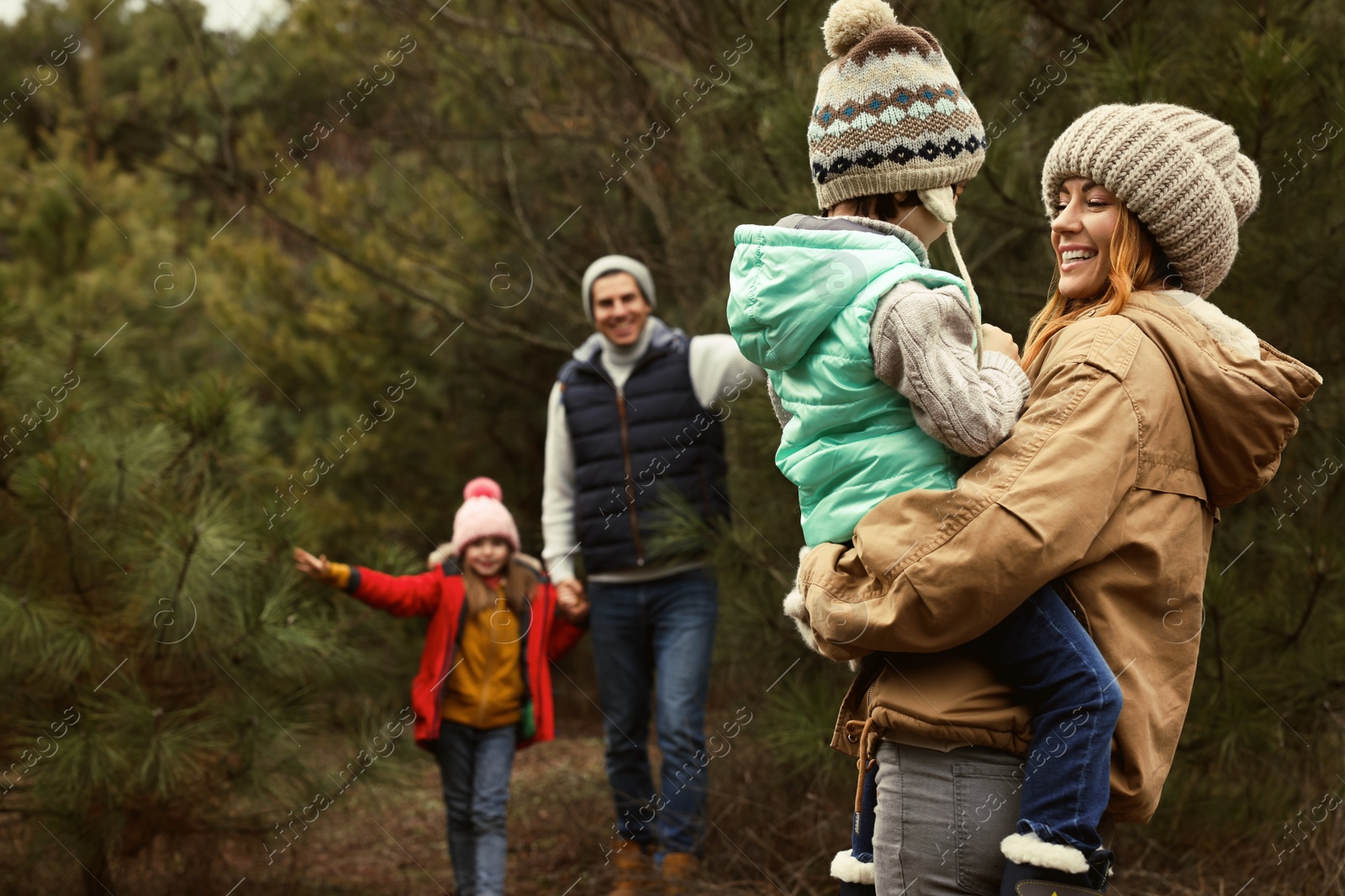 Photo of Happy family spending time together in forest