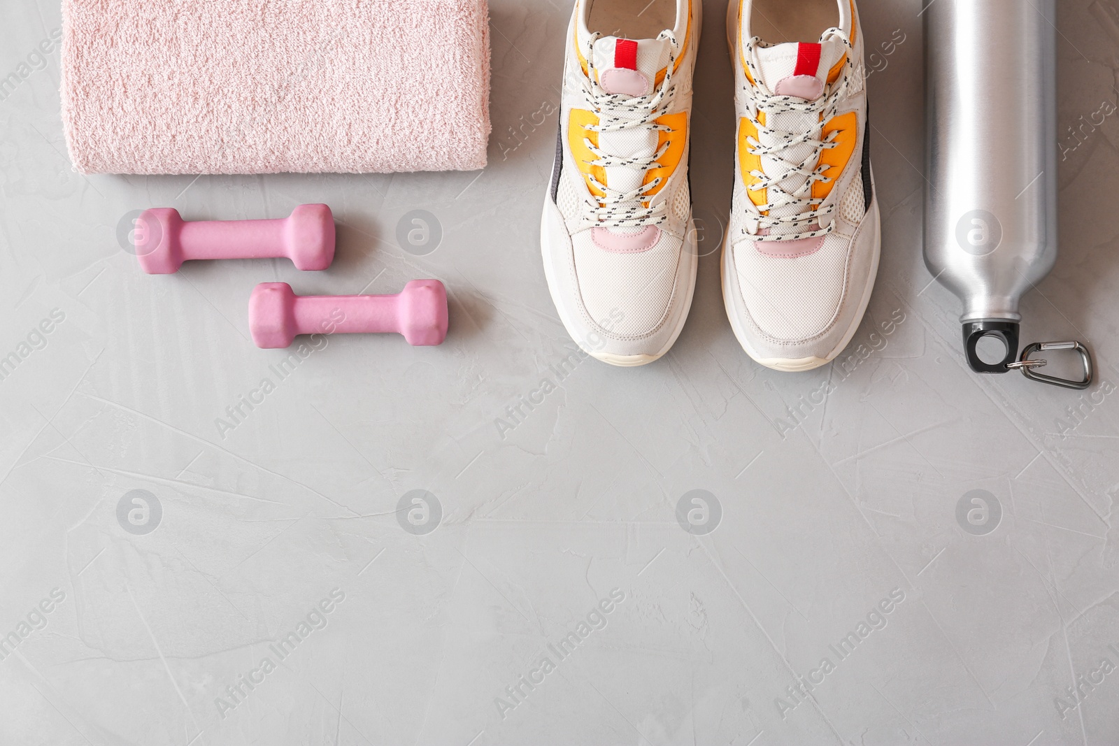 Photo of Flat lay composition with fitness equipment and space for text on gray background