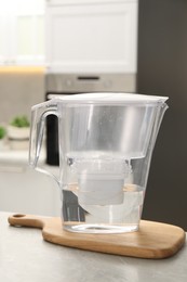 Water filter jug on light table in kitchen