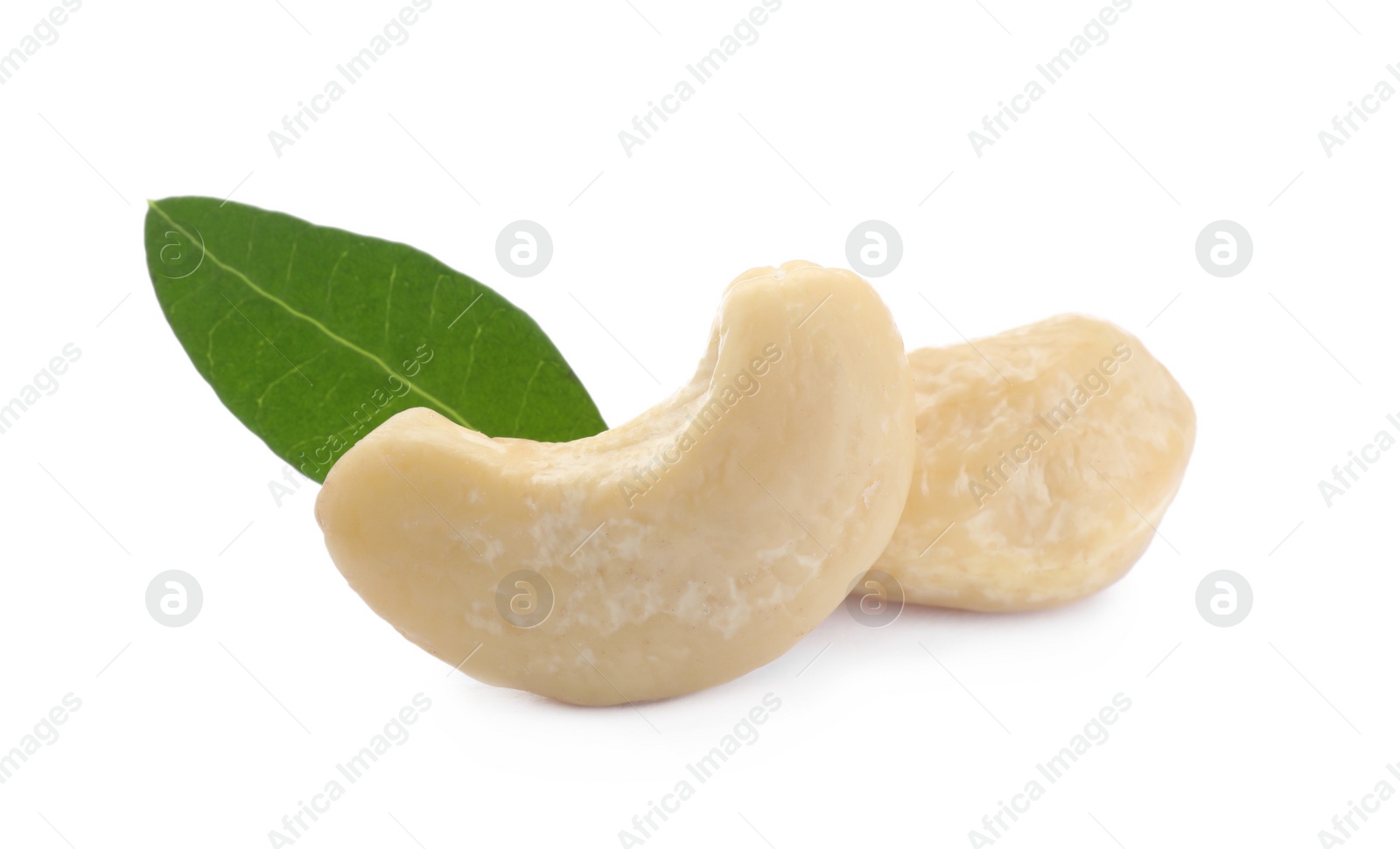 Photo of Tasty organic cashew nuts and green leaf isolated on white