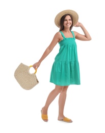 Young woman with stylish straw bag on white background