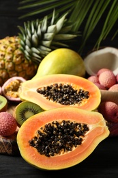 Photo of Fresh ripe papaya and other fruits on table, closeup