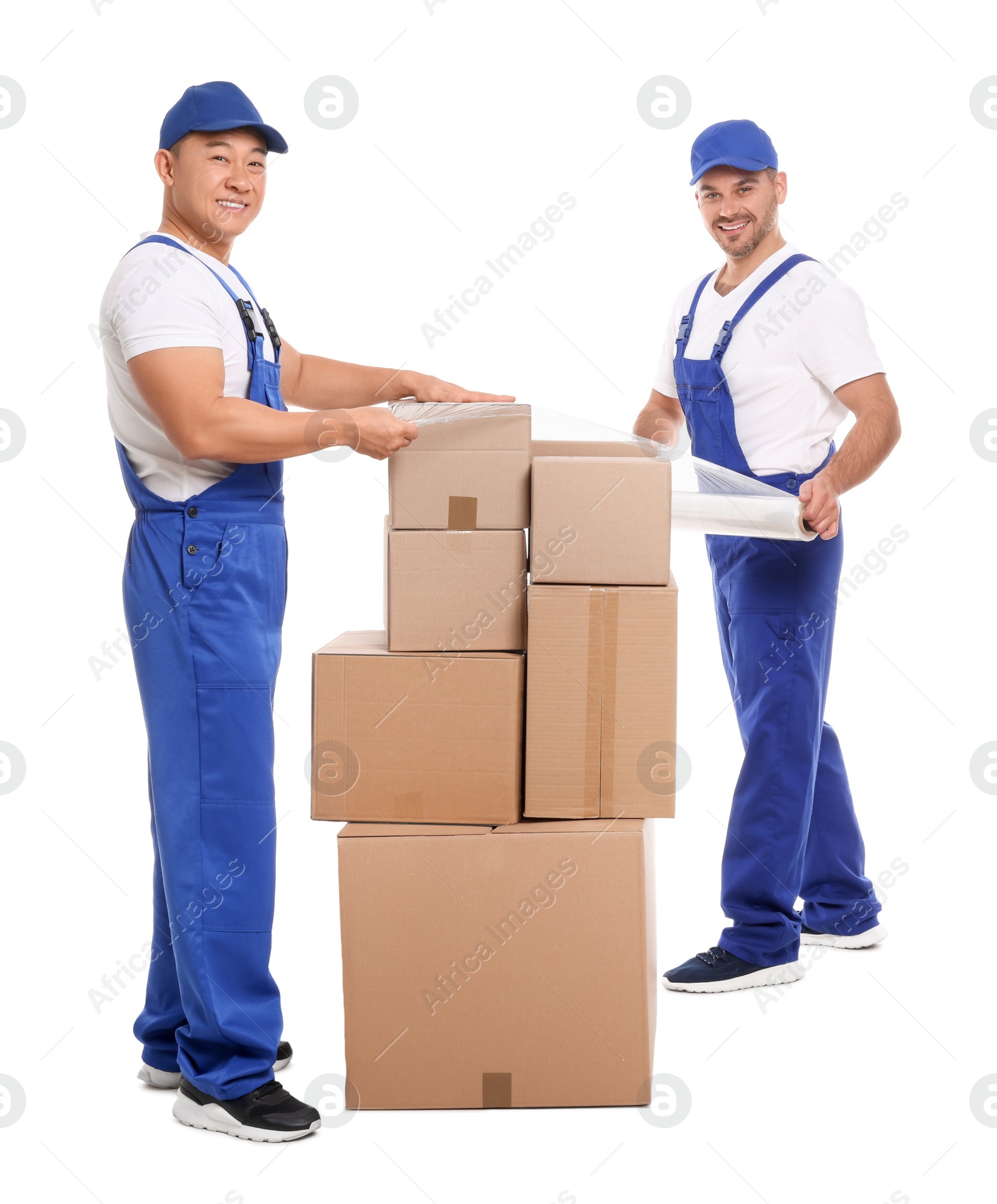 Photo of Workers wrapping boxes in stretch film on white background