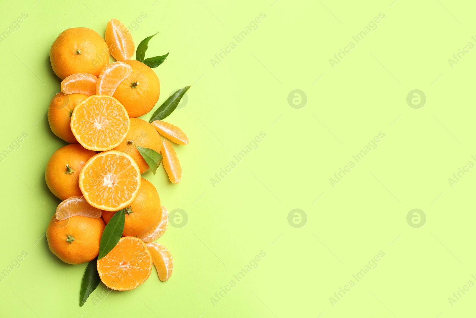 Photo of Composition with tangerines and leaves on color background, flat lay. Space for text