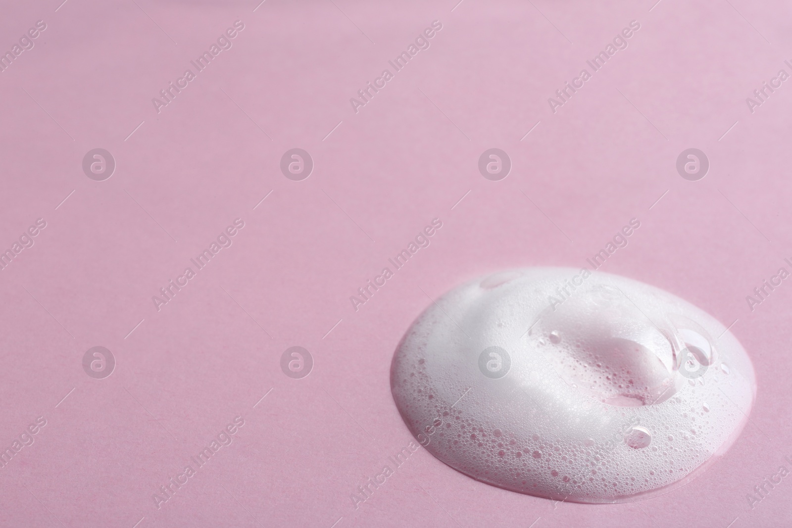 Photo of Drop of soap foam on color background. Space for text